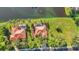 Overhead shot of two homes with pools, tile roofs, and manicured lawns by the water at 17188 Cape Horn Blvd, Punta Gorda, FL 33955