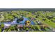 Aerial view of a home situated on a lake in a lush green community with expansive lawns at 17188 Cape Horn Blvd, Punta Gorda, FL 33955