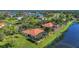 Stunning aerial of waterfront home featuring a screened-in pool and lush landscaping at 17188 Cape Horn Blvd, Punta Gorda, FL 33955