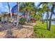 Landscaped backyard with rock beds and palm trees, offering serene water views and privacy at 17188 Cape Horn Blvd, Punta Gorda, FL 33955
