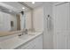 Bright bathroom featuring a large mirror, white cabinets, and modern fixtures at 17188 Cape Horn Blvd, Punta Gorda, FL 33955