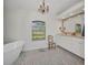 A bathtub and vanity with white cabinets are featured in this bathroom at 17188 Cape Horn Blvd, Punta Gorda, FL 33955