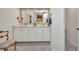 A bathroom with dual sinks, white cabinets, and a large mirror at 17188 Cape Horn Blvd, Punta Gorda, FL 33955
