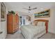 Cozy bedroom with tile floor, ceiling fan, and French doors leading to the outdoors at 17188 Cape Horn Blvd, Punta Gorda, FL 33955