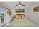 Bright bedroom with art on the walls, ceiling fan, and outdoor access at 17188 Cape Horn Blvd, Punta Gorda, FL 33955