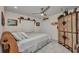 Charming bedroom featuring bright white tile floor, unique armoire, and ceiling fan at 17188 Cape Horn Blvd, Punta Gorda, FL 33955