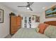 Comfortable bedroom with ceiling fan, unique armoire, and French doors at 17188 Cape Horn Blvd, Punta Gorda, FL 33955