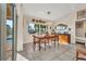 Bright dining area features a wooden table, view of pool, and stylish decor at 17188 Cape Horn Blvd, Punta Gorda, FL 33955