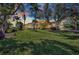 Lush green lawn and landscaped front yard with a home framed by palm trees at sunset at 17188 Cape Horn Blvd, Punta Gorda, FL 33955