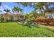Beautiful home featuring a well-manicured lawn, vibrant landscaping, and a charming red tile roof at 17188 Cape Horn Blvd, Punta Gorda, FL 33955