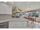 Kitchen offers quartz counters, white cabinets, stainless appliances, and natural light at 17188 Cape Horn Blvd, Punta Gorda, FL 33955
