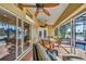 Inviting lanai featuring a dining set, outdoor seating, and sliding glass doors with a water view at 17188 Cape Horn Blvd, Punta Gorda, FL 33955