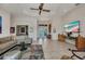 Bright and open living area showcasing tile flooring, a comfortable sofa, and modern entertainment setup at 17188 Cape Horn Blvd, Punta Gorda, FL 33955