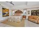 The primary bedroom offers a tray ceiling, seating area, and tile floors at 17188 Cape Horn Blvd, Punta Gorda, FL 33955