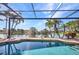 Relaxing pool offers serene water views, a screened enclosure, and lush tropical landscaping at 17188 Cape Horn Blvd, Punta Gorda, FL 33955