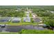 Aerial view of a neighborhood of waterfront homes, lush green lawns and screened-in pools near a canal at 17200 Gulfspray Cir, Port Charlotte, FL 33948