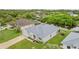 Aerial view of a one-story home with lush landscaping and a serene waterway in the backyard at 17200 Gulfspray Cir, Port Charlotte, FL 33948