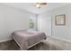 Neutral bedroom with a ceiling fan, carpeted floors, a double door closet, and a window letting in natural light at 17200 Gulfspray Cir, Port Charlotte, FL 33948