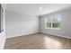 Bright, empty room with modern floors and a large window providing ample natural light at 17200 Gulfspray Cir, Port Charlotte, FL 33948