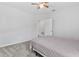 Neutral bedroom with a ceiling fan, carpeted floors, and a doorway leading to other rooms at 17200 Gulfspray Cir, Port Charlotte, FL 33948