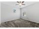 Carpeted spare bedroom with a ceiling fan, a window, and a simple decor for comfortable living at 17200 Gulfspray Cir, Port Charlotte, FL 33948