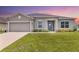 Charming one-story home with blue shutters, manicured lawn, and inviting curb appeal at 17200 Gulfspray Cir, Port Charlotte, FL 33948