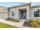 Inviting one-story home with a well-maintained lawn, blue shutters, and a charming entrance at 17200 Gulfspray Cir, Port Charlotte, FL 33948