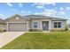 Charming one-story home with blue shutters, manicured lawn, and inviting curb appeal at 17200 Gulfspray Cir, Port Charlotte, FL 33948