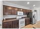 Kitchen features dark cabinetry, stainless steel appliances and laminate countertops at 17200 Gulfspray Cir, Port Charlotte, FL 33948