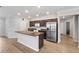 Spacious kitchen with a large island, dark cabinets, and stainless steel refrigerator at 17200 Gulfspray Cir, Port Charlotte, FL 33948