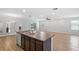 Bright open kitchen features an island with a stainless steel sink and spacious living area at 17200 Gulfspray Cir, Port Charlotte, FL 33948