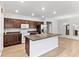Modern kitchen with dark wood cabinets, stainless steel appliances, and center island at 17200 Gulfspray Cir, Port Charlotte, FL 33948
