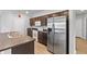 Updated kitchen with dark cabinets, stainless steel appliances, and a center island at 17200 Gulfspray Cir, Port Charlotte, FL 33948