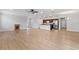 Open floor plan with light wood floors, kitchen, and living area at 17200 Gulfspray Cir, Port Charlotte, FL 33948