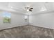 Spacious main bedroom with tray ceiling, ceiling fan, and bright windows at 17200 Gulfspray Cir, Port Charlotte, FL 33948
