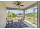 Cozy screened patio with ceiling fan offering waterfront views for outdoor relaxation and entertainment at 17200 Gulfspray Cir, Port Charlotte, FL 33948