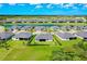 Aerial view of houses with manicured lawns surrounding golf course and lake in a beautiful community at 17336 Sandpearl Rd, Venice, FL 34293