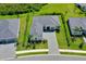Stunning aerial view of a single-Gathering home with a grey tile roof and lush landscaping at 17336 Sandpearl Rd, Venice, FL 34293