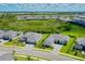 Scenic aerial view of homes with grey tile roofs in a community near a natural reserve at 17336 Sandpearl Rd, Venice, FL 34293