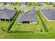 Birds-eye view of a private backyard, green lawn, and manicured hedges surrounding the property at 17336 Sandpearl Rd, Venice, FL 34293
