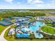 Aerial view of the community pool and tennis courts, showcasing lush landscaping and resort-style amenities at 17336 Sandpearl Rd, Venice, FL 34293