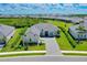 Expansive aerial view of a home with lush green landscaping in a serene residential community at 17336 Sandpearl Rd, Venice, FL 34293