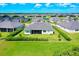 A high angle view of a home with a well-manicured lawn and screened in back porch at 17336 Sandpearl Rd, Venice, FL 34293