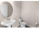 Modern half bathroom with a pedestal sink and tiled floors for a clean and fresh look at 17336 Sandpearl Rd, Venice, FL 34293