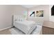 Well-lit bedroom boasting a plush bed, stylish artwork, and luxury vinyl tile flooring at 17336 Sandpearl Rd, Venice, FL 34293