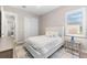 Comfortable bedroom featuring a plush bed, natural light, and a stylish rug at 17336 Sandpearl Rd, Venice, FL 34293