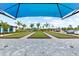 Outdoor bocce ball courts with manicured green surfaces, surrounded by landscaping and paved walkways at 17336 Sandpearl Rd, Venice, FL 34293