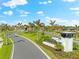 Wellen Park entrance with lush landscaping, decorative signage, and palm tree-lined street at 17336 Sandpearl Rd, Venice, FL 34293