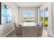 Cozy dining area features a modern round table and sliding glass doors at 17336 Sandpearl Rd, Venice, FL 34293