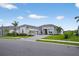 Beautiful single Gathering home with grey tile roof, paver driveway, and mature landscaping at 17336 Sandpearl Rd, Venice, FL 34293